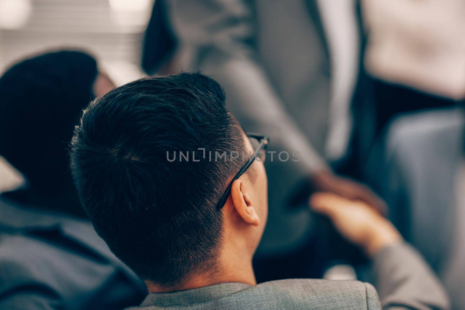 close up. young businessman works in an office. rear view