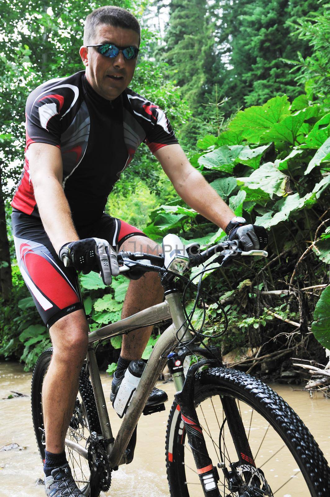 healthy lifestyle and fitness concept with mount bike man who ride bike  outdoor