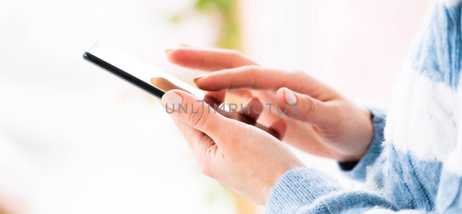 Female hands using phone by GekaSkr