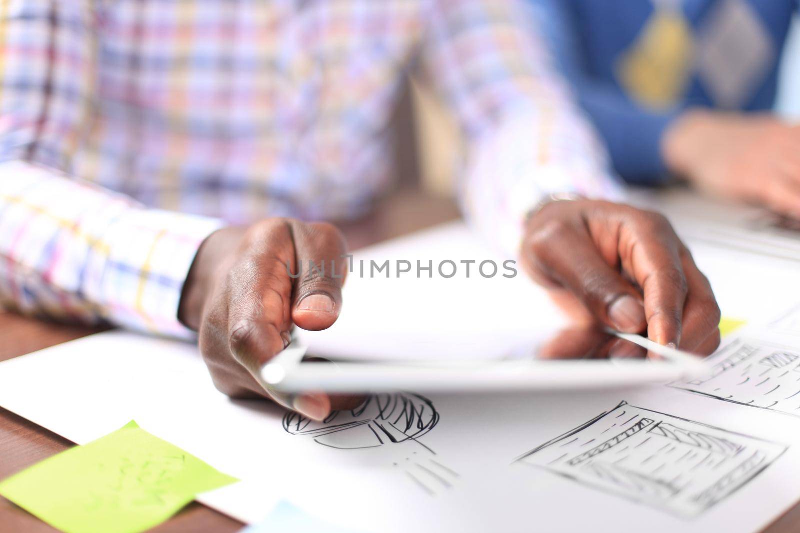 Close-up image of an office worker using a touchpad to analyze statistical data