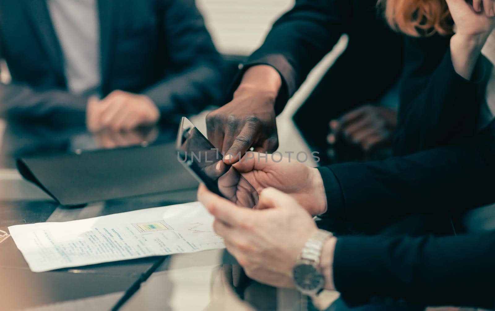 close up. business colleagues viewing messages on a smartphone. people and technology