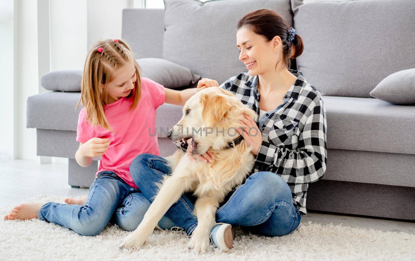 Mother and daughter playing with dog by GekaSkr