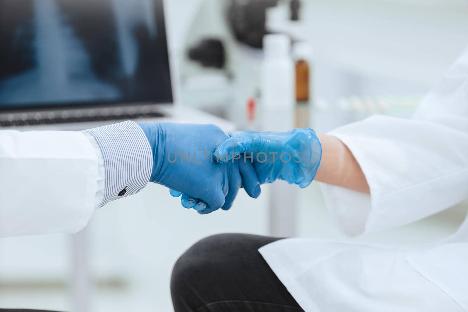 close up. medical scientists shaking hands in the lab. concept of success.