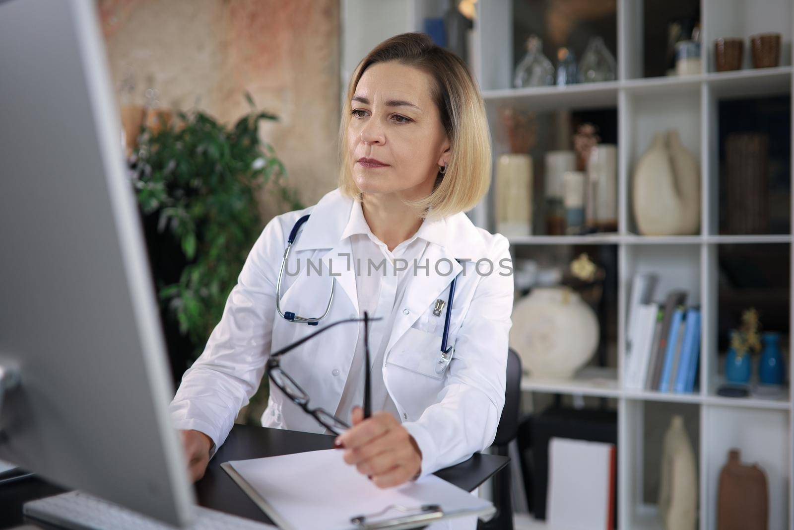 Middle aged female doctor therapist on consultation