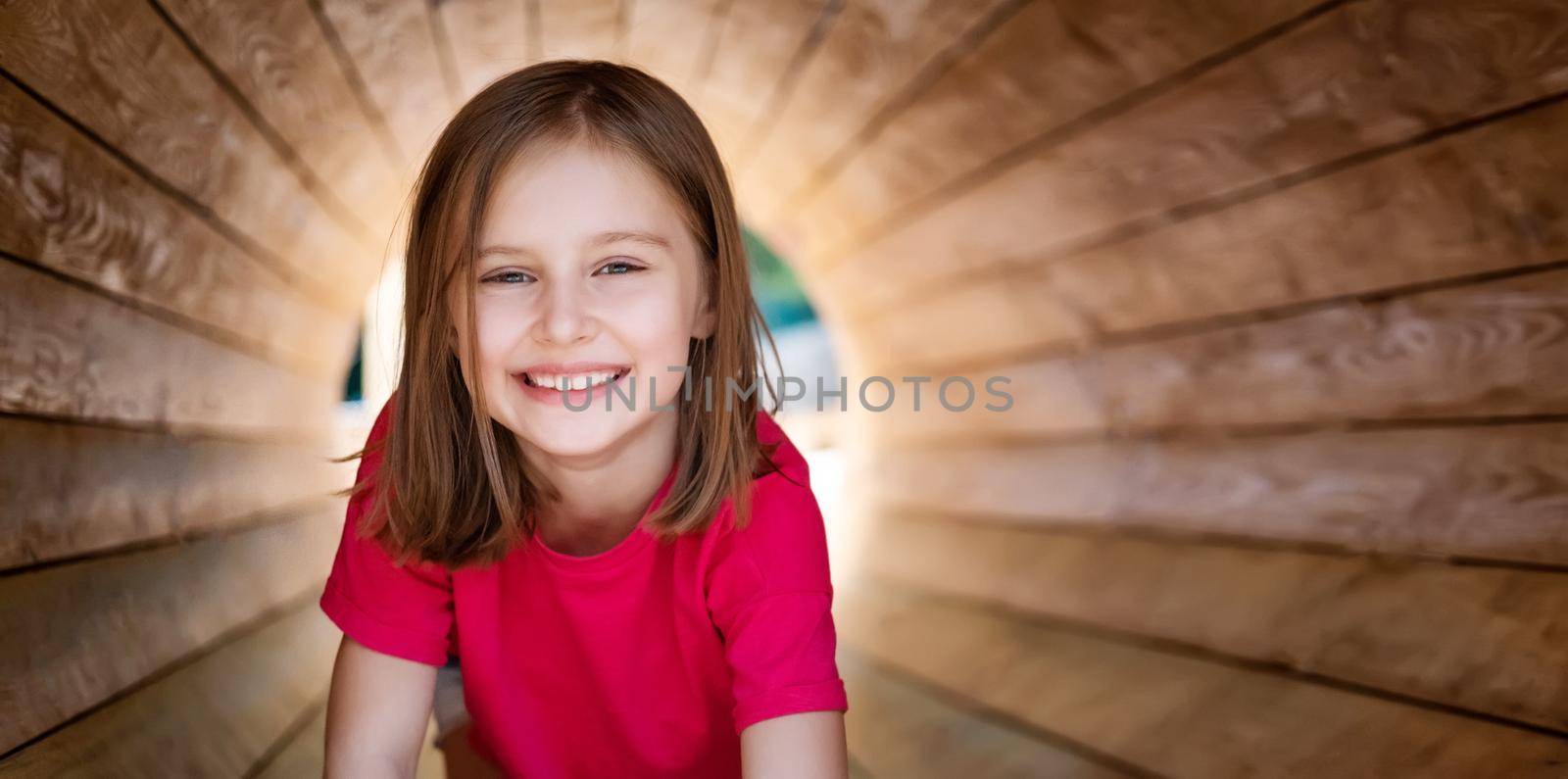 Smiling little girl in wooden pipe by GekaSkr