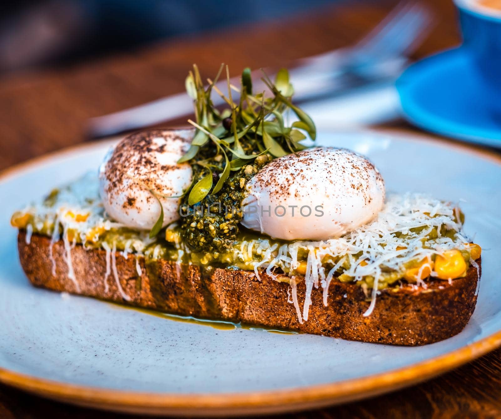 Close up view of appetizing mushroom sandwich on blue round plate