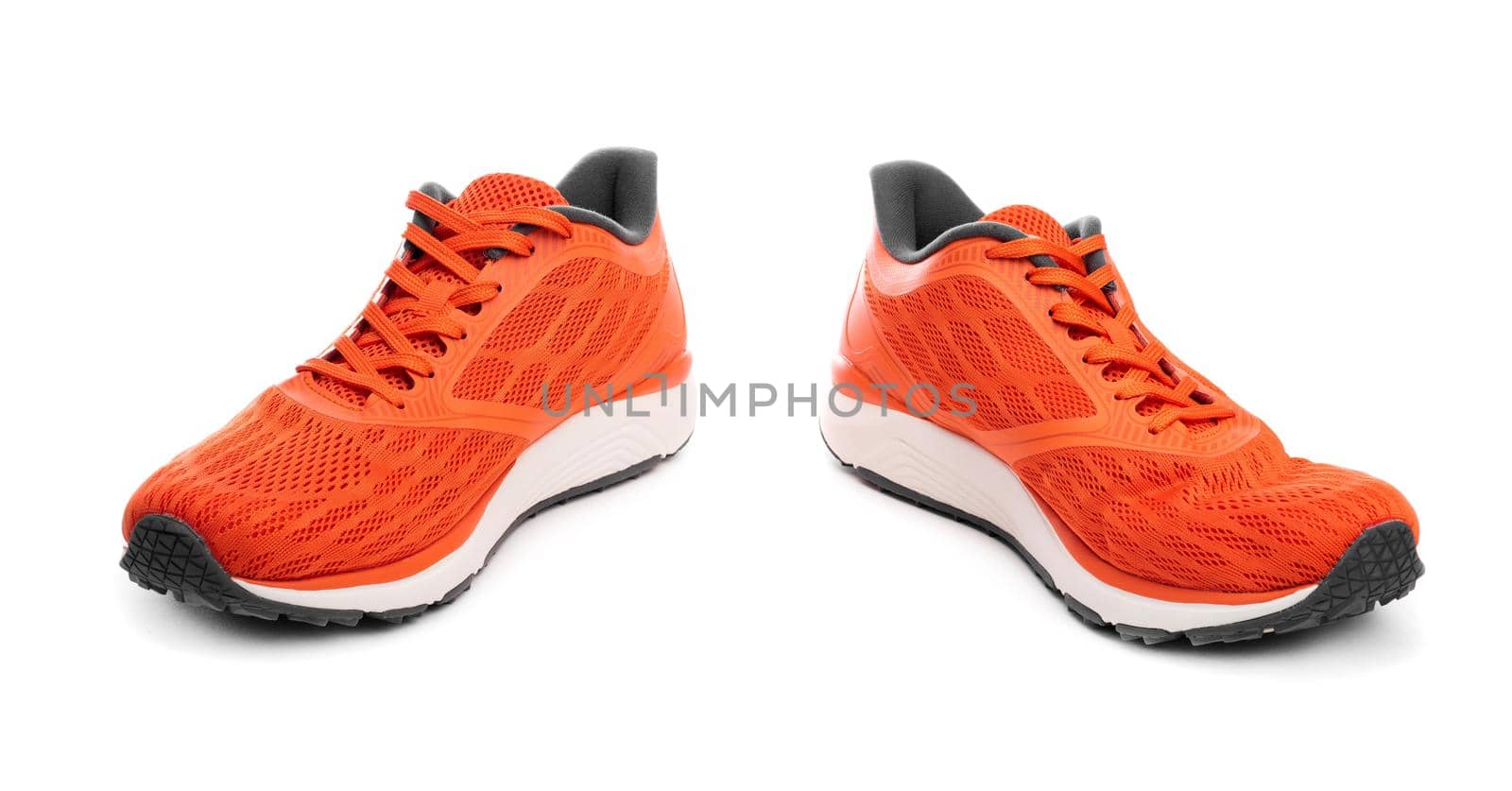 Pair of orange sport sneakers isolated on white background