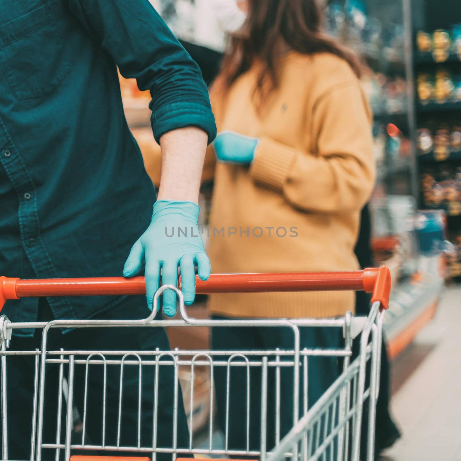 shoppers in protective masks choosing fruit in the supermarket by SmartPhotoLab