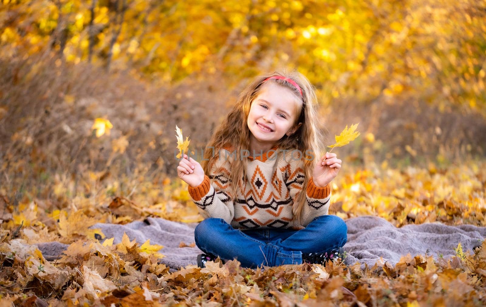 Little girl holding yellow leaves by GekaSkr