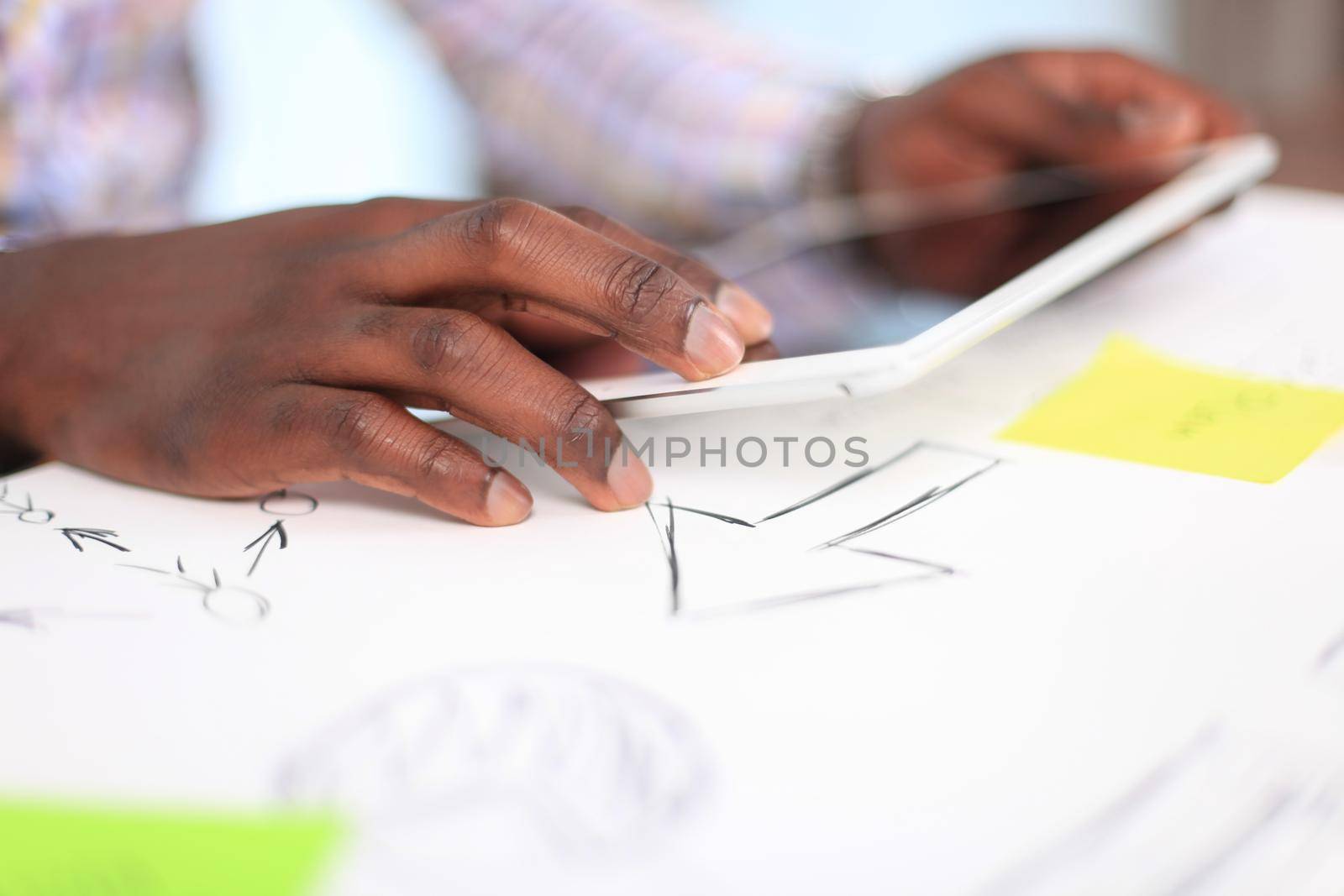 Close-up image of an office worker using a touchpad to analyze statistical data