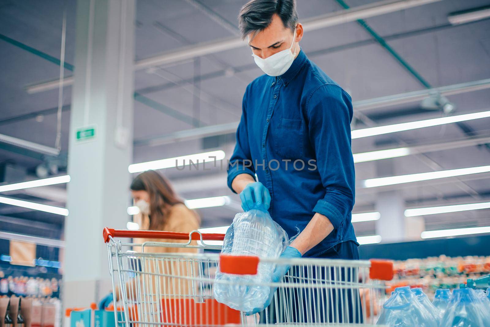 shoppers in protective masks choosing products in the supermarket. security concept