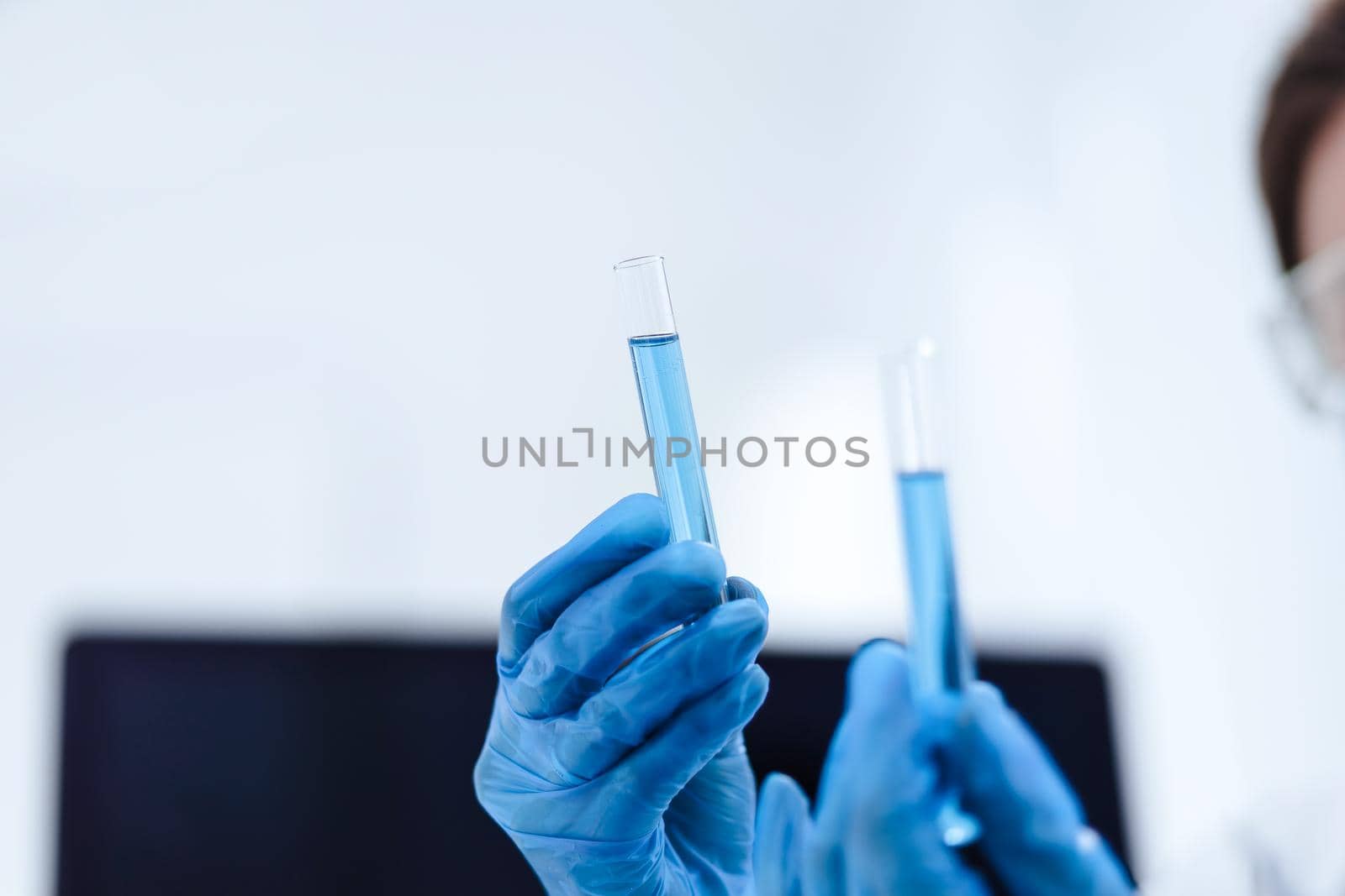 close up. tubes with tests in the hands of a woman scientist . photo with a copy-space.