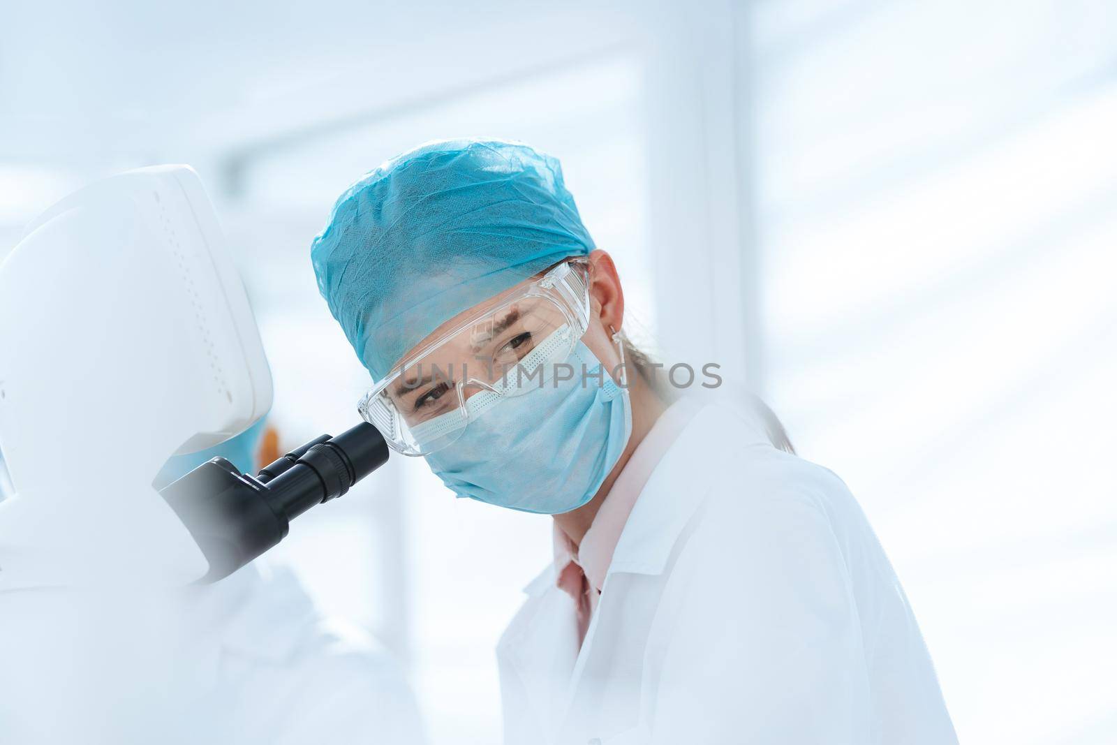 close up. female scientist conducts research in a medical laboratory. science and health protection.