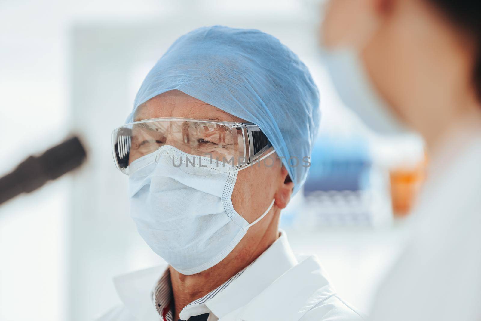 close up. female scientist looking through a microscope . science and public health.