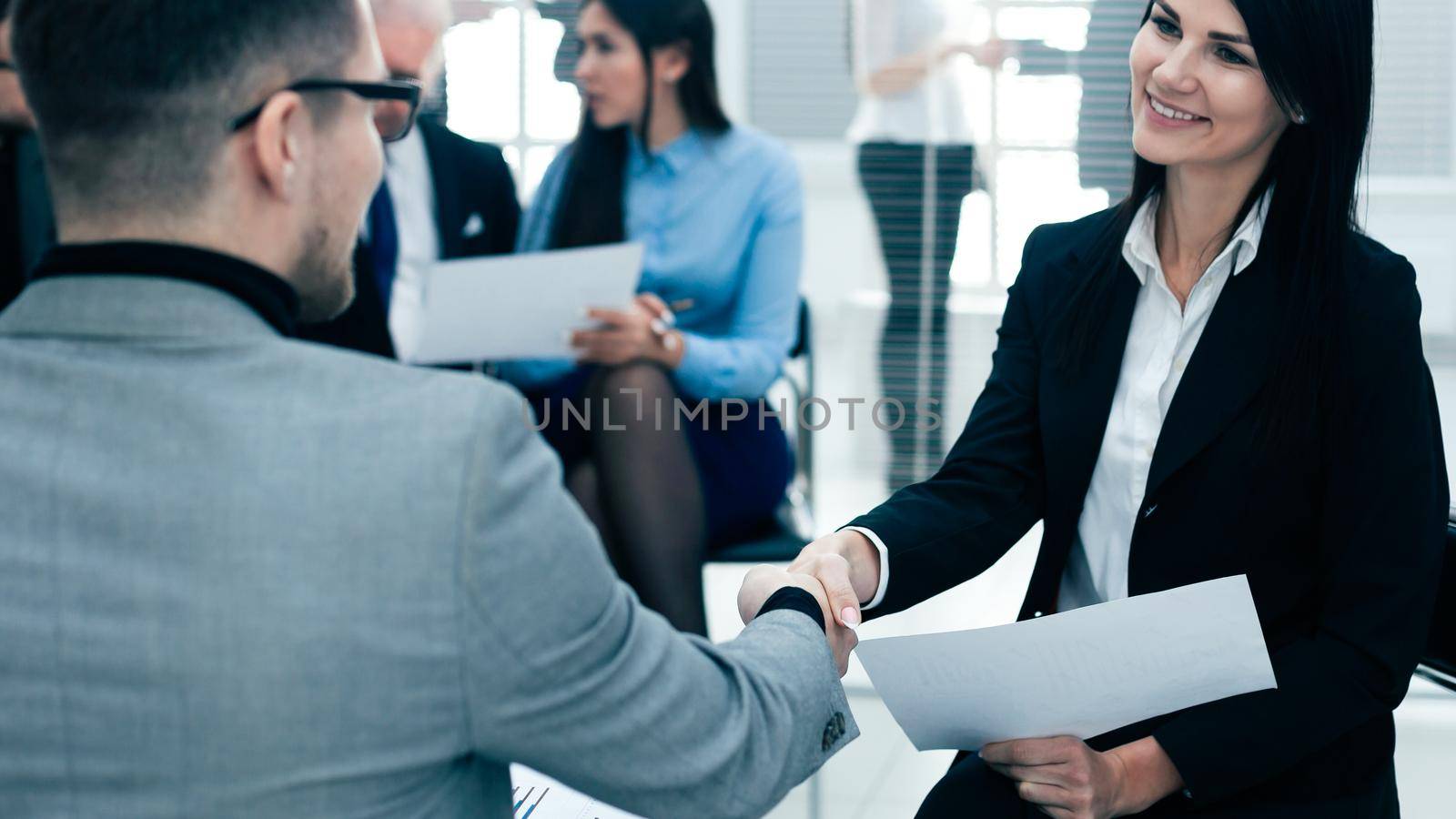 close up. businesswoman shaking hands with her business partner. concept of cooperation