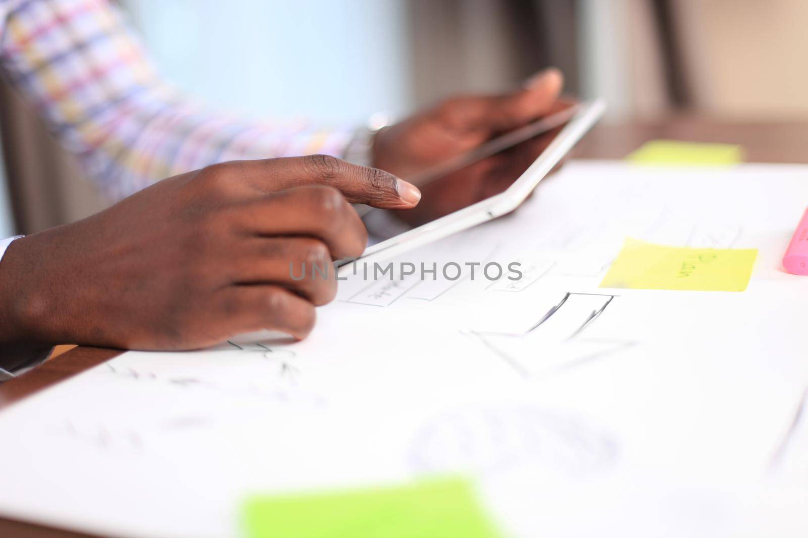 Close up image of an office worker using a touchpad to analyze statistical data by tsyhun