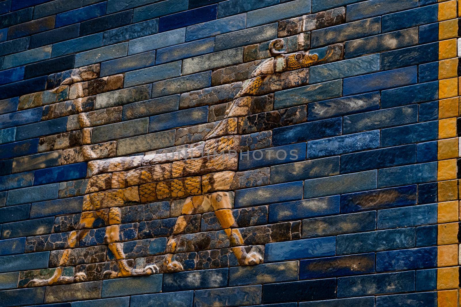 The Ishtar gate in the Pergamon museum in Berlin, Germany. Ancient Altar mosaic of Babylon Mesopotamian city, Iraq with dragon. Old art treasure of archeology and civilization