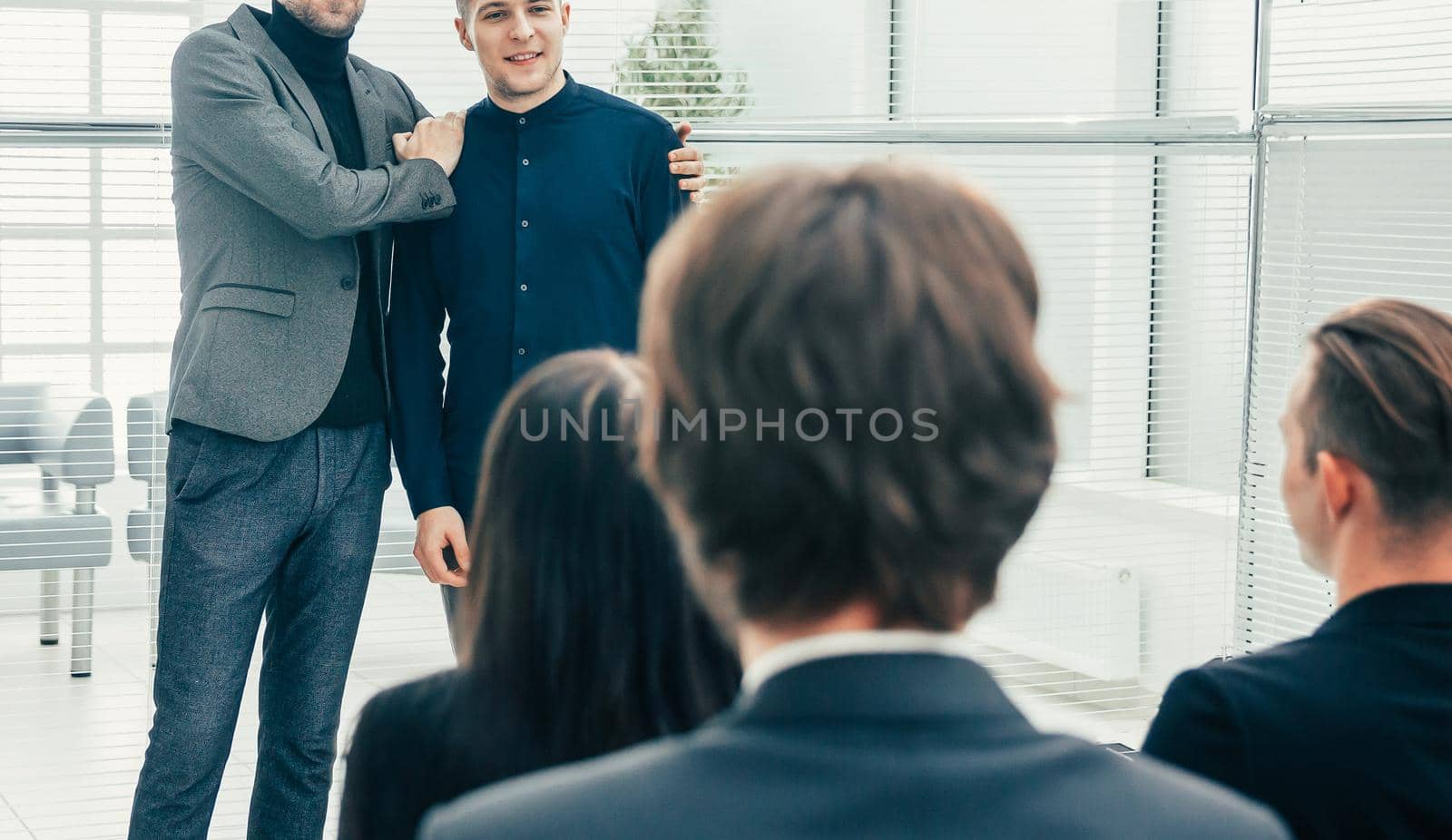 close up. Manager introducing a new employee at a meeting with the business tea