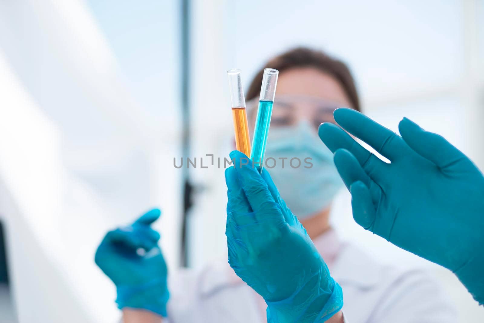 close up. tubes with tests in the hands of a woman scientist . photo with a copy-space.