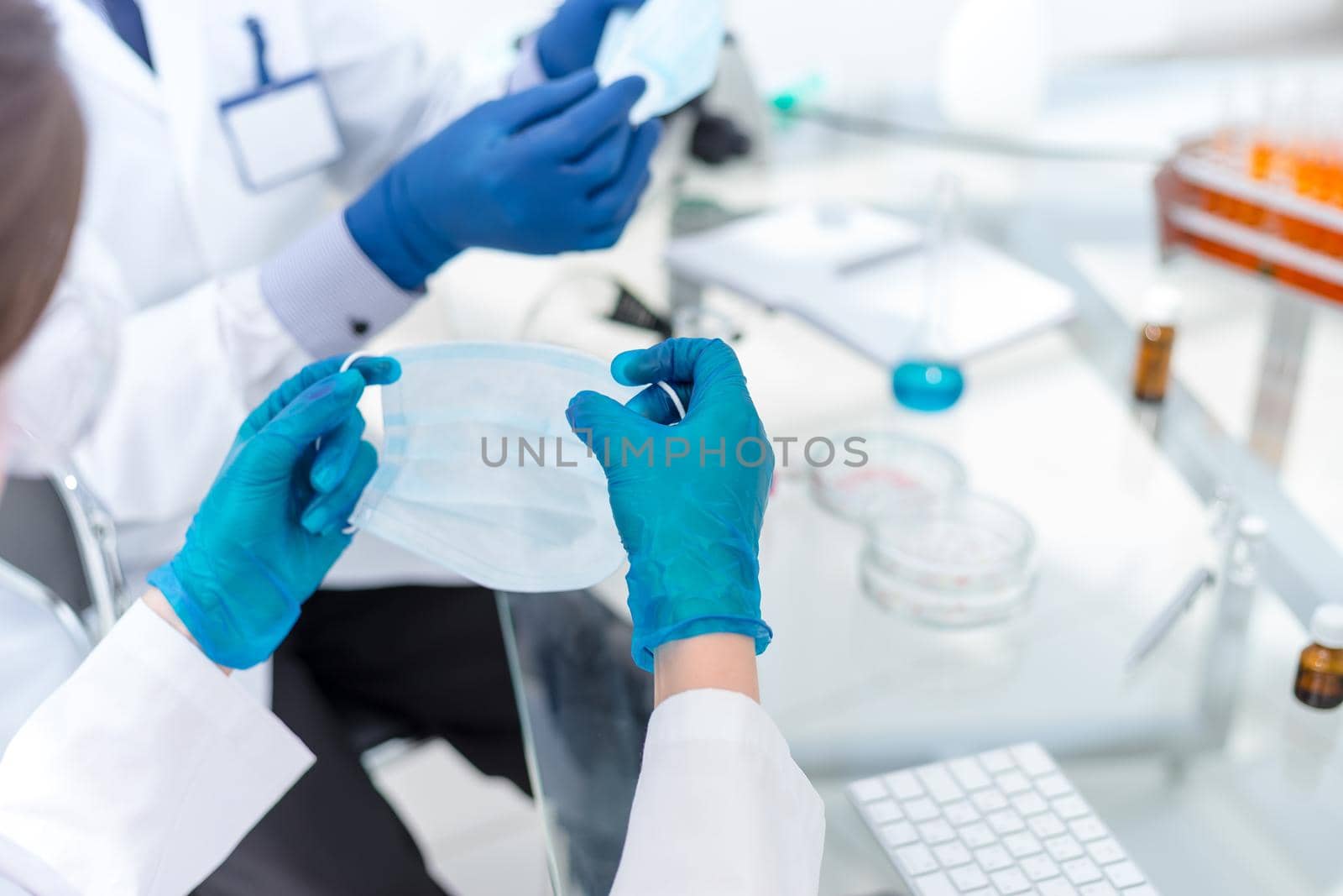close up. laboratory employees wearing protective masks. science and health.