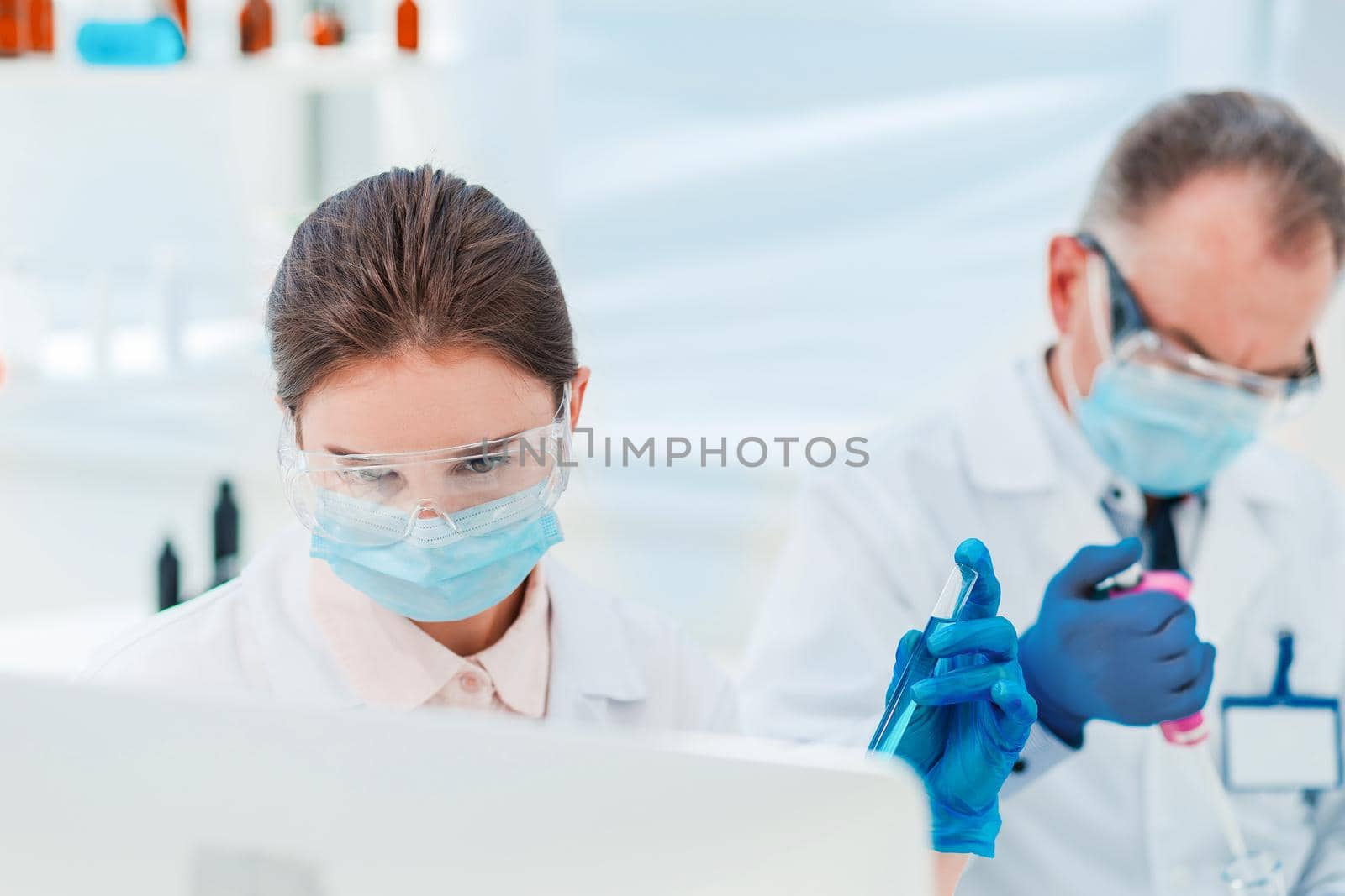 close up. female scientist with a test tube in her hands. science and health.