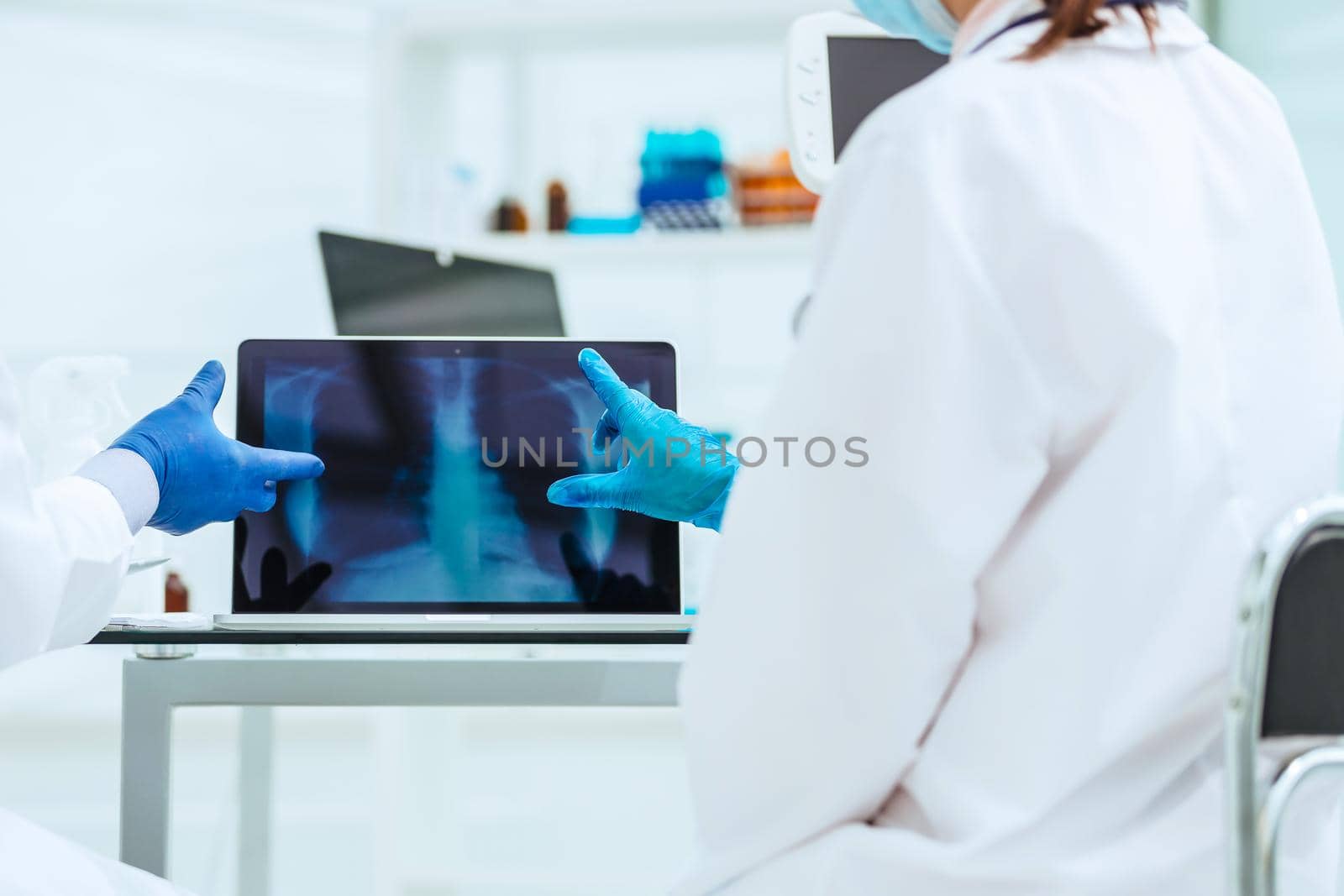 close up. attending doctors use a laptop to check the x-ray. concept of health care.