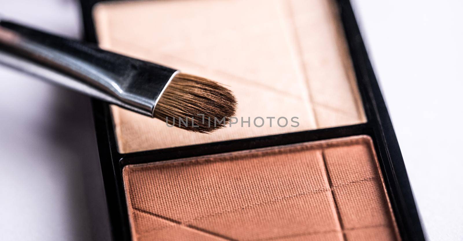 Makeup brush and set of pastel shadows
