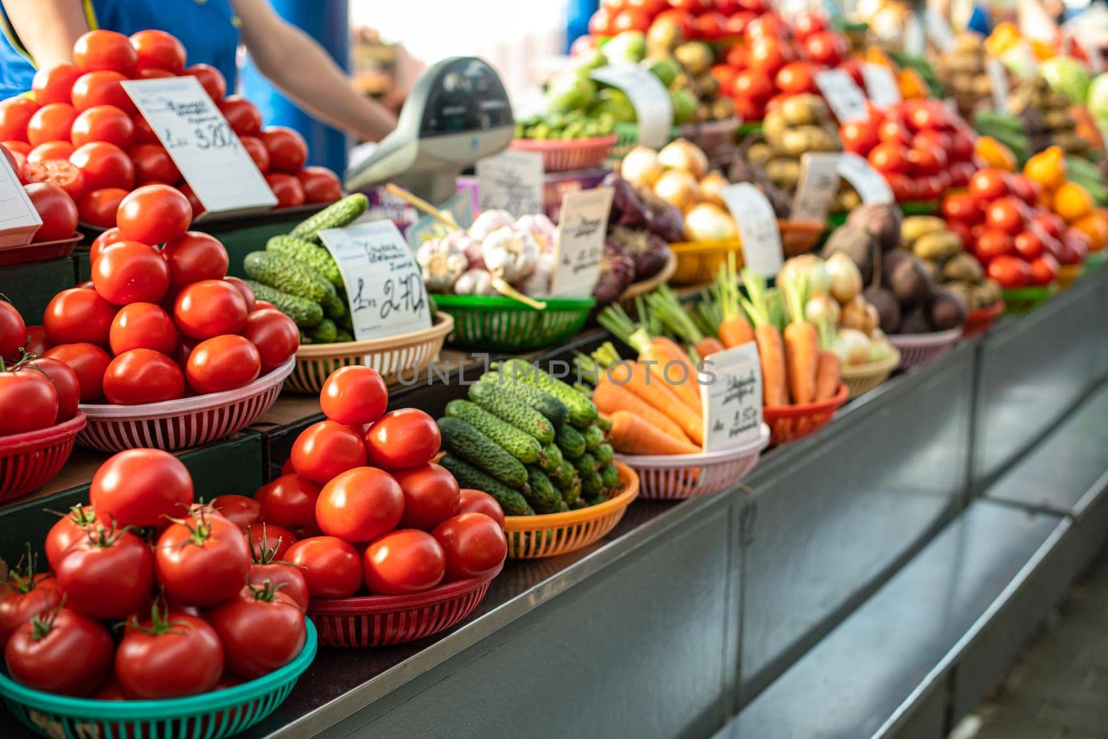 Different fresh vegetables in baskets on counter. by StudioLucky