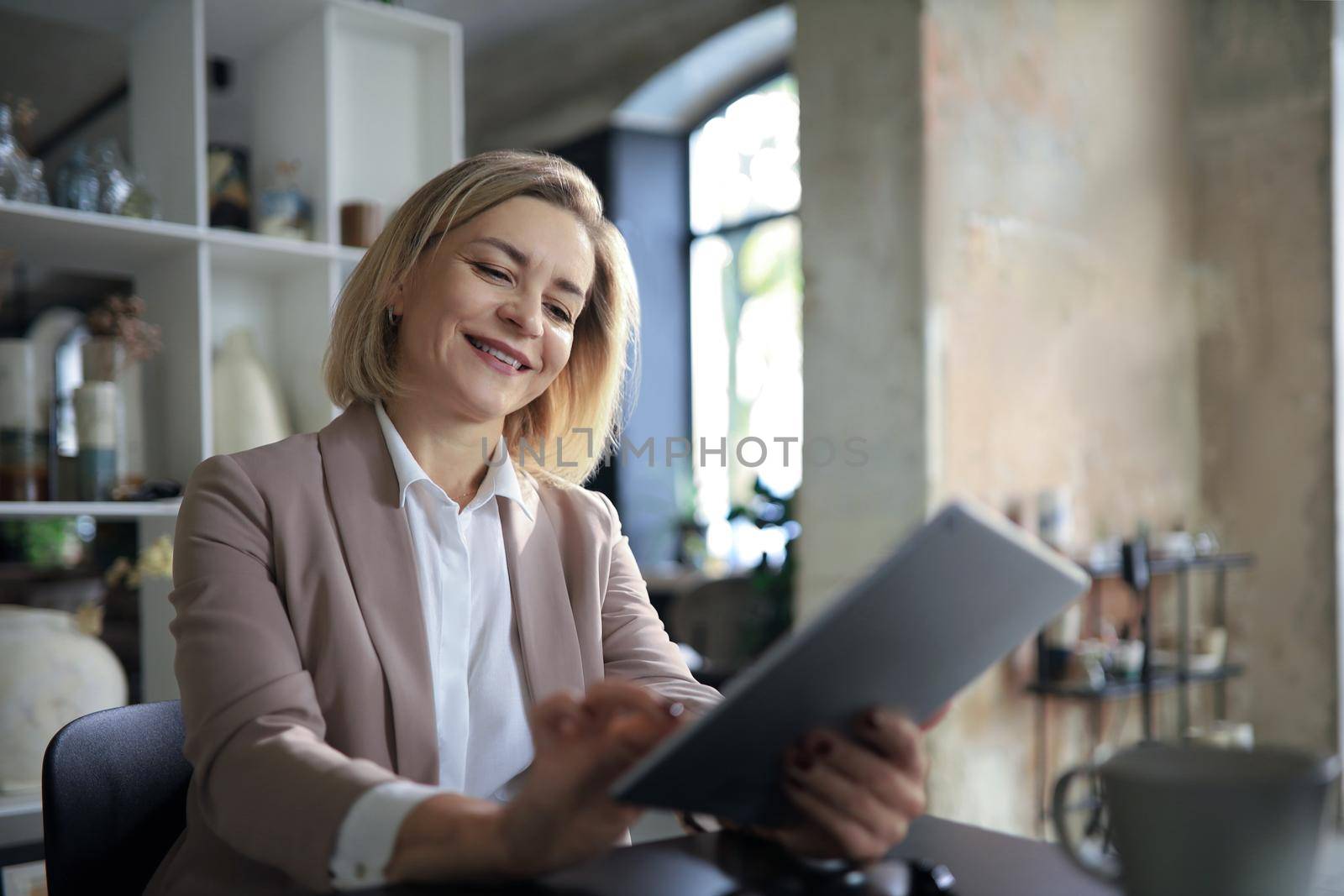 Beautiful business woman on the workplace using a digital tablet
