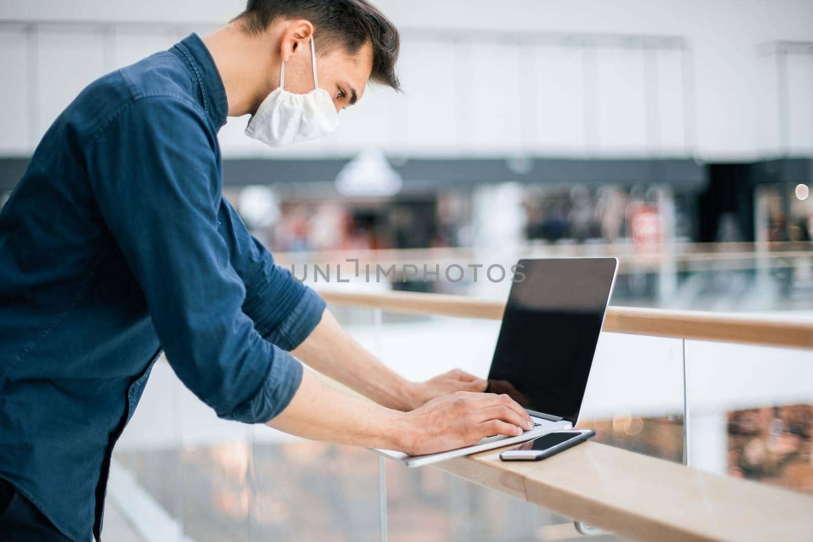 close up. a young man in a protective mask using a laptop. photo with a copy of the space
