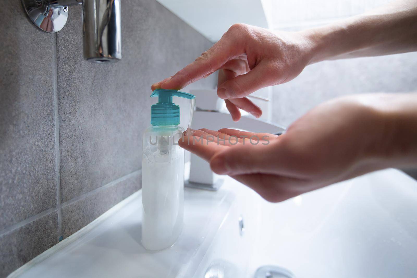 close up. man using liquid bactericidal hand soap. concept of health protection.