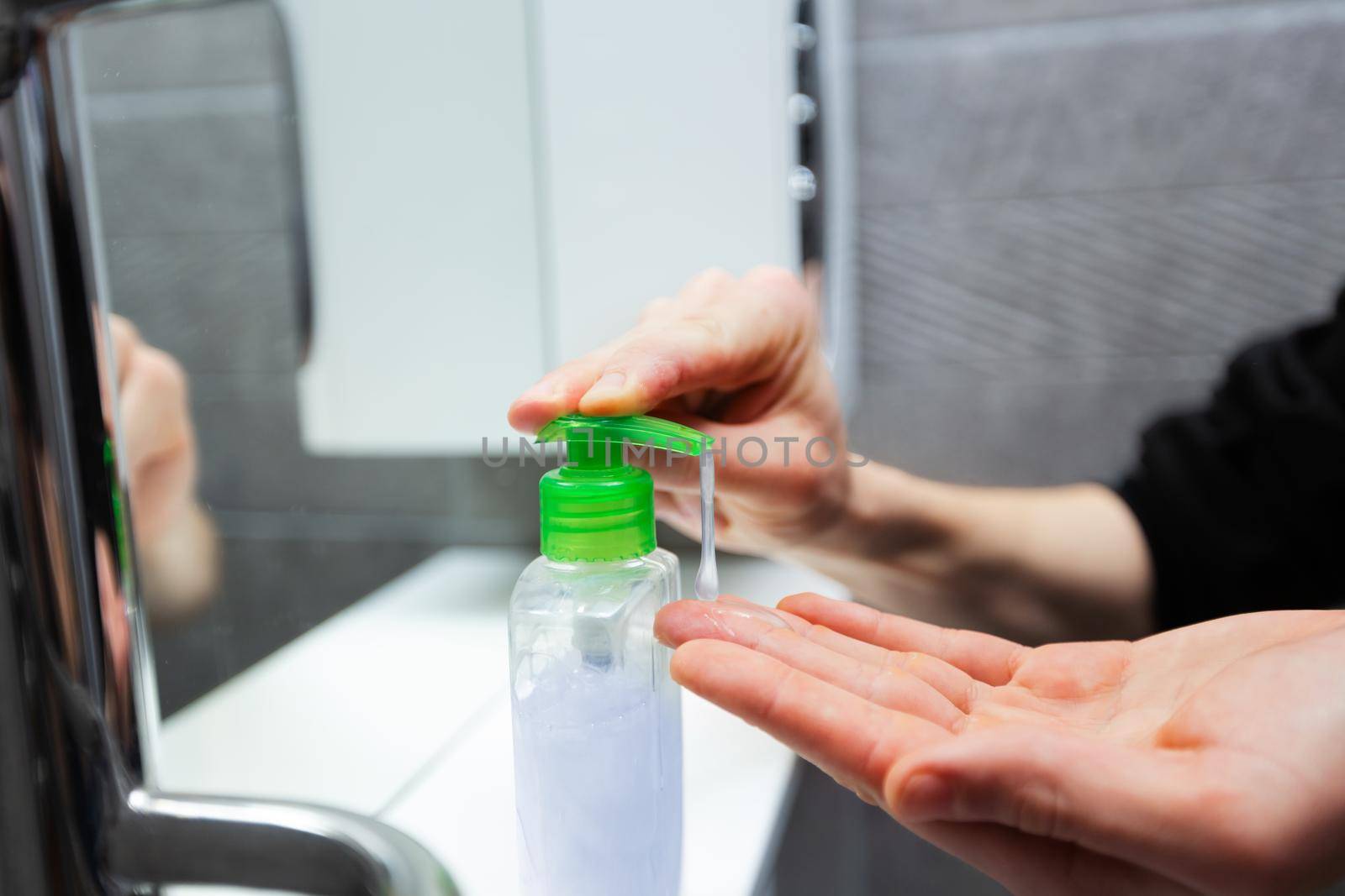 close up. man puts liquid soap on his hands . concept of health protection.