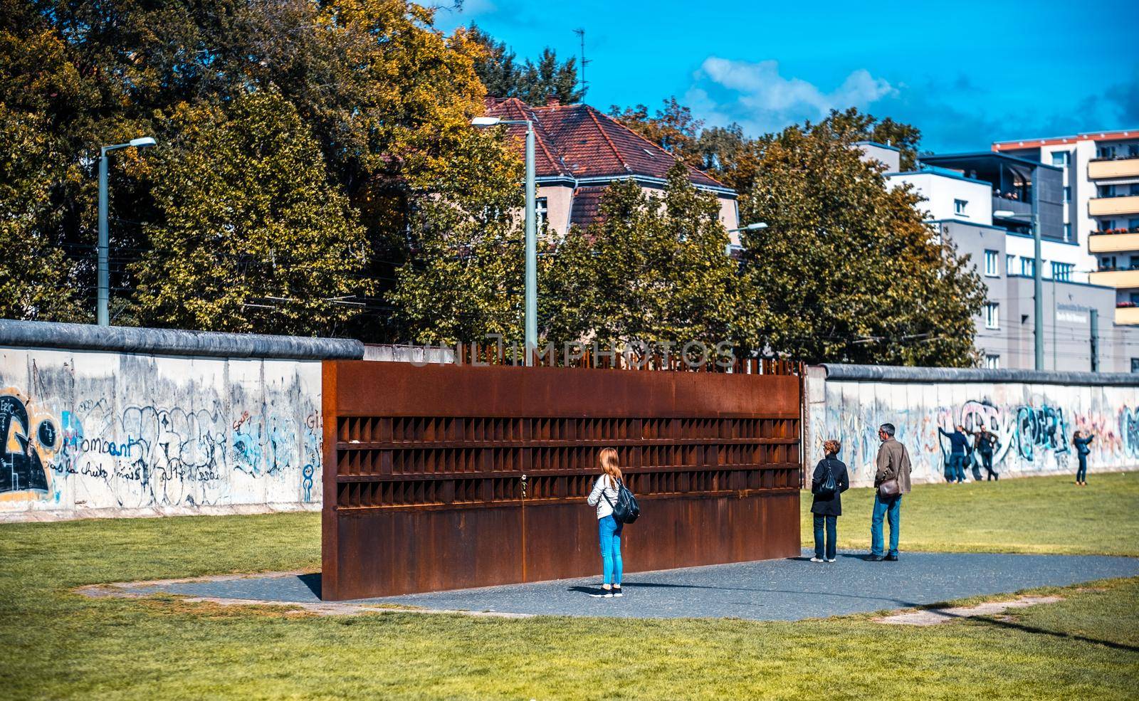 Berlin, Germany - 20 September 2019: Tourists near Berlin Wall memorial at sunny day