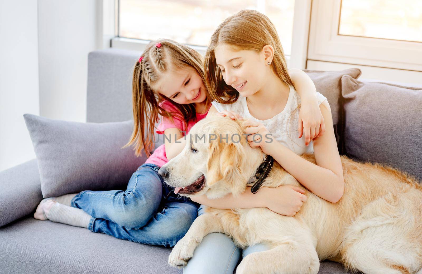 Happy sisters cuddling cute dog by GekaSkr
