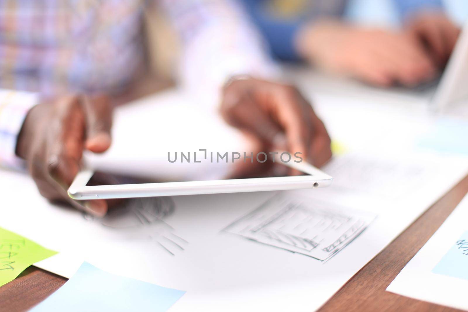 Close up image of an office worker using a touchpad to analyze statistical data by tsyhun