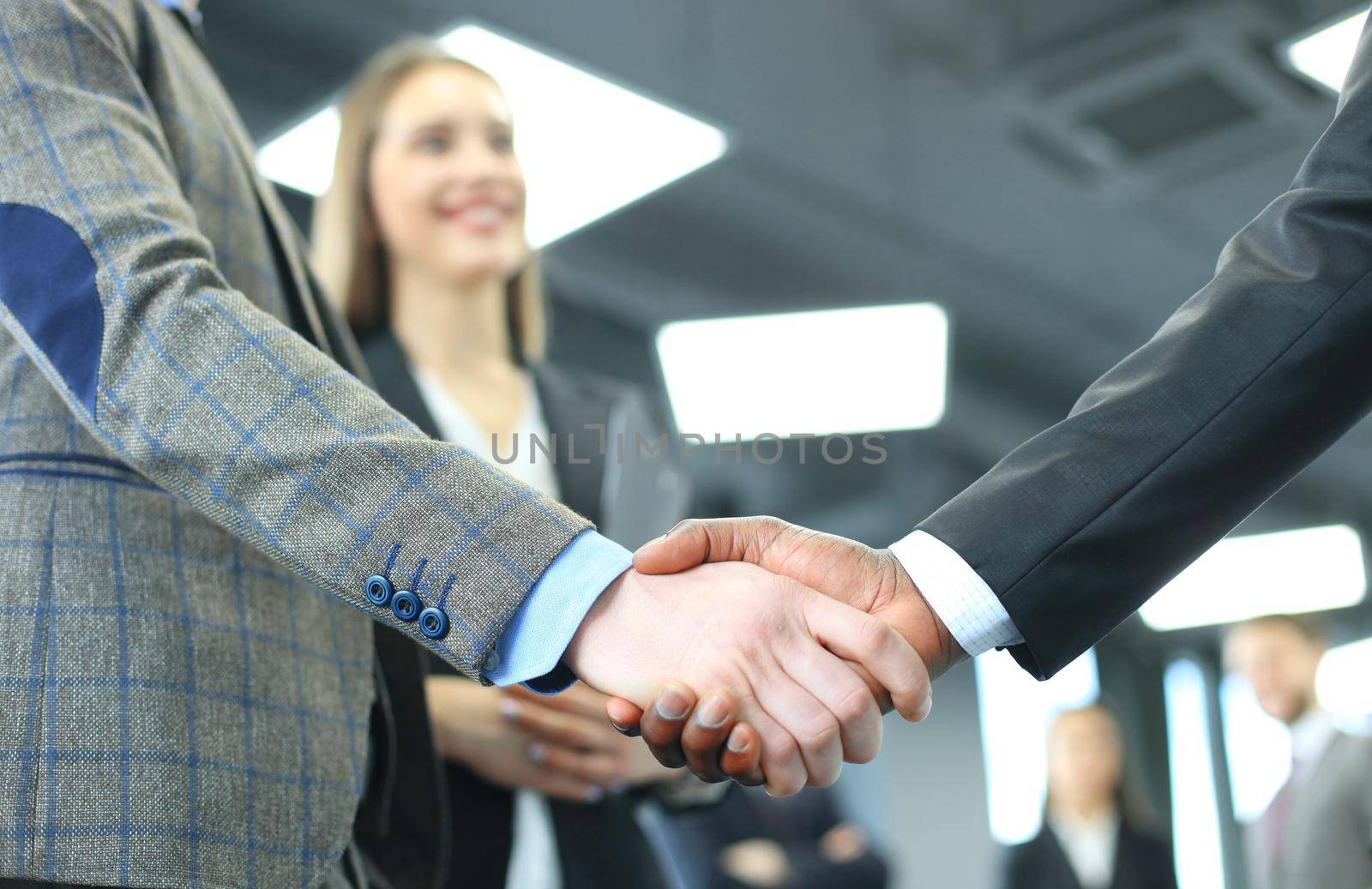 Business people shaking hands, finishing up a meeting by tsyhun