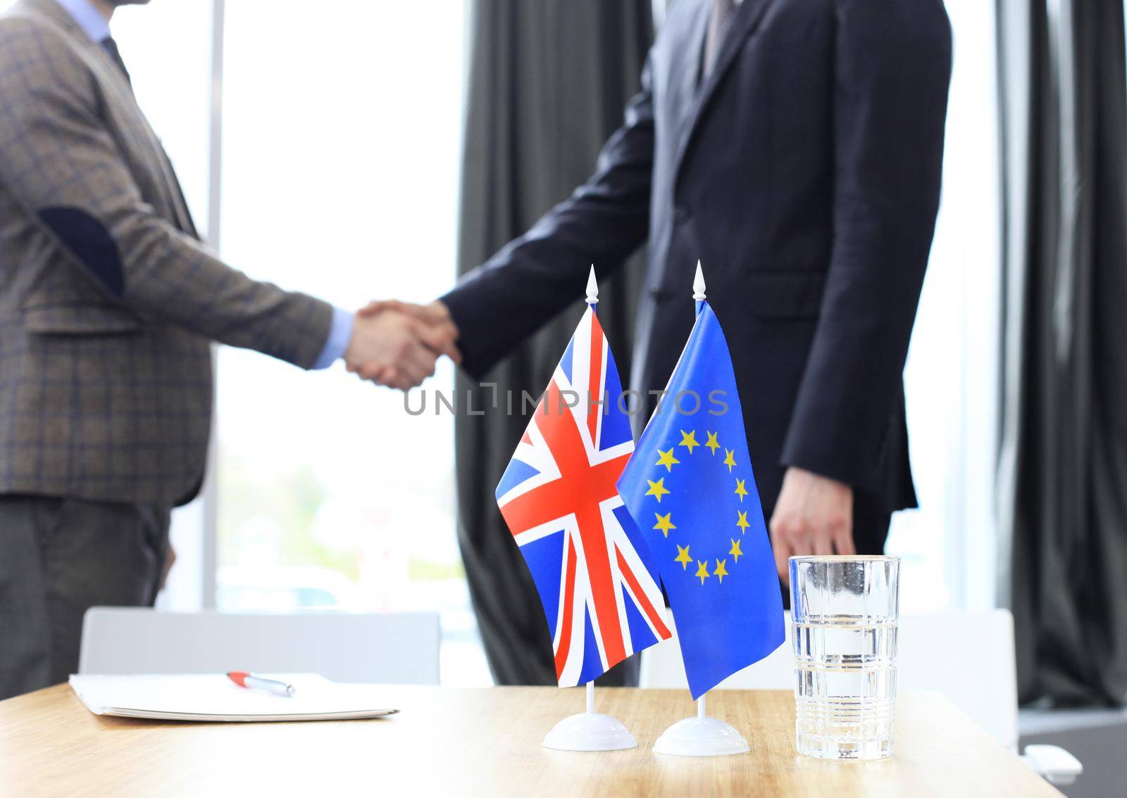 European Union and United Kingdom leaders shaking hands on a deal agreement by tsyhun