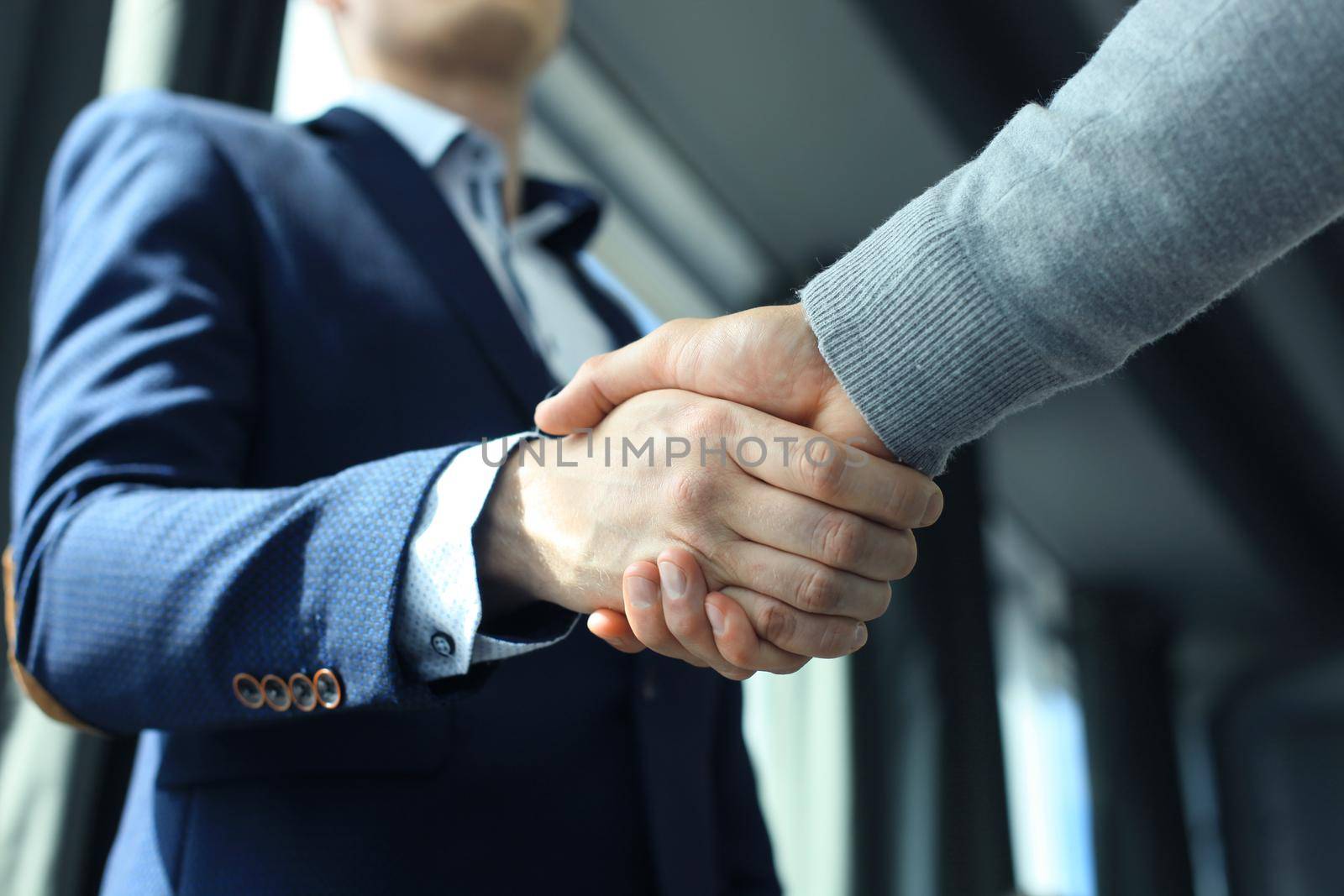 Business people shaking hands, finishing up a meeting by tsyhun