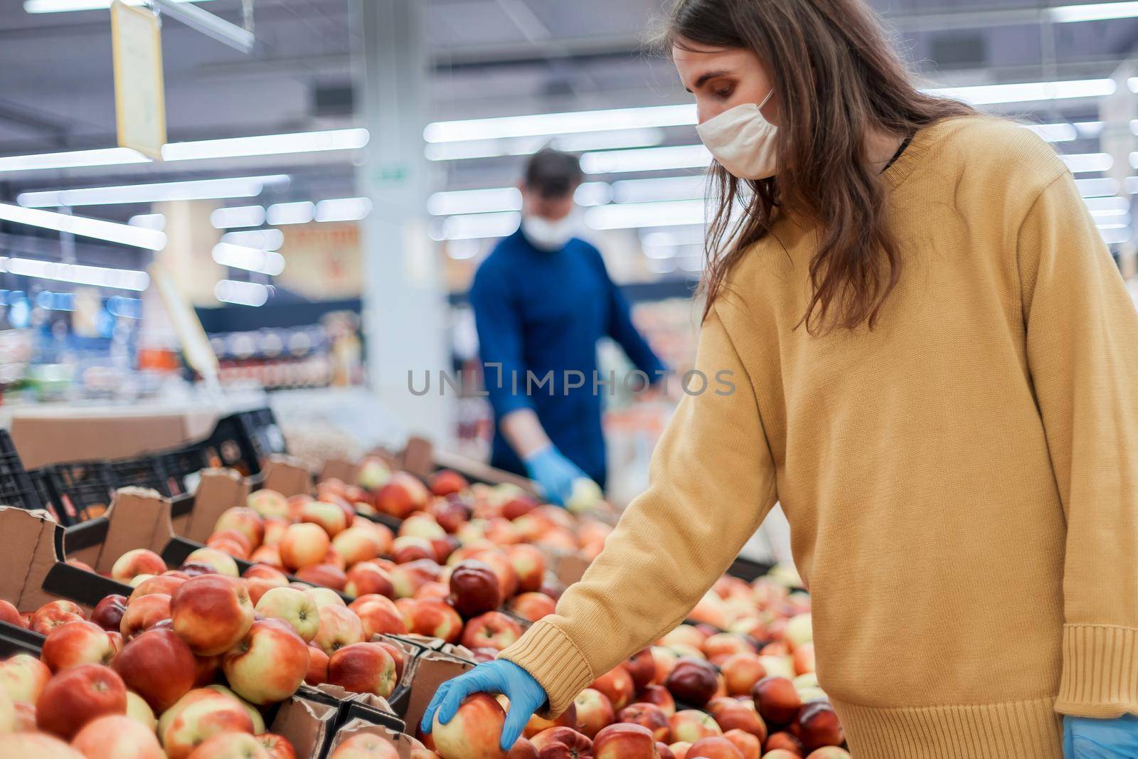casual woman in protective gear buying fruit during the quarantine period. security concept