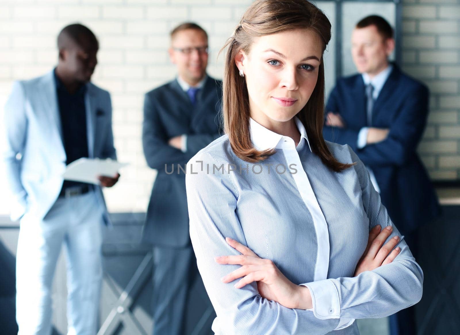 business woman with her staff, people group in background at modern bright office indoors