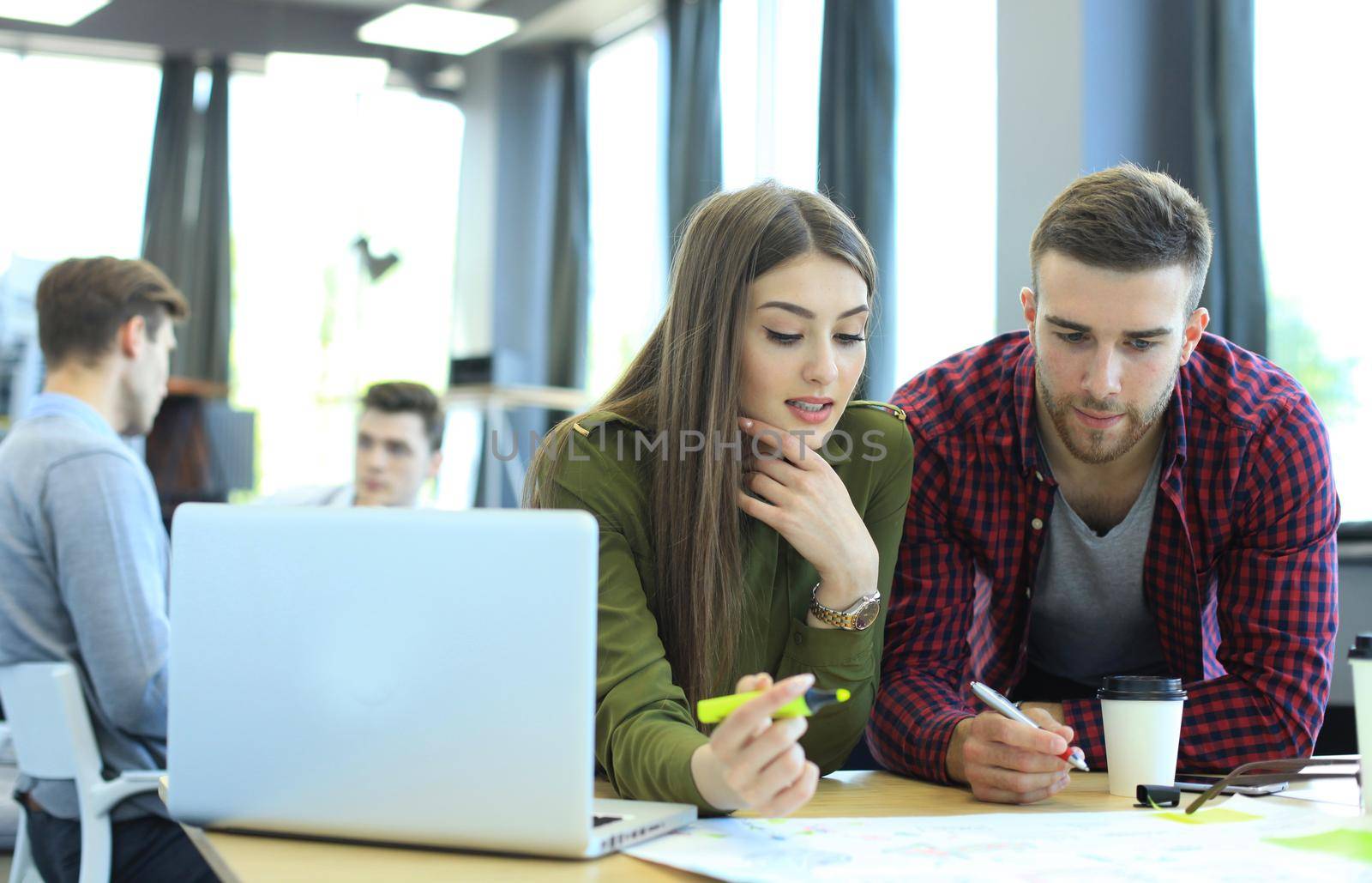 Young group of people doing their jobs on laptop.