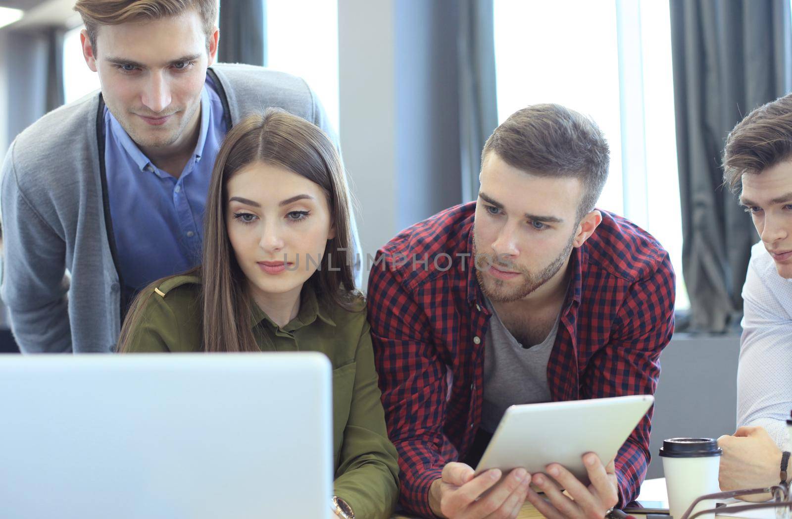 Young group of people doing their jobs on laptop.