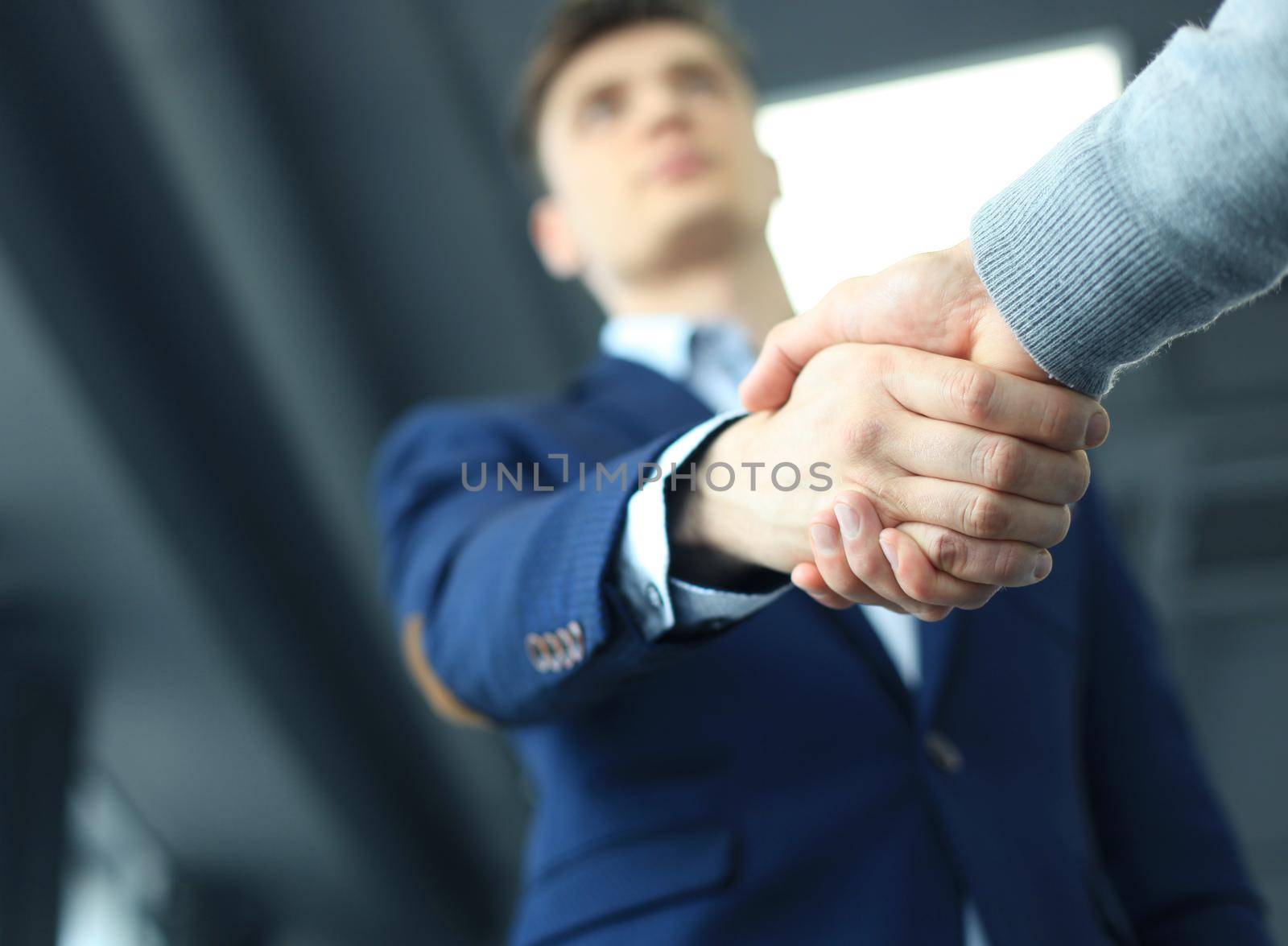 Business people shaking hands, finishing up a meeting by tsyhun