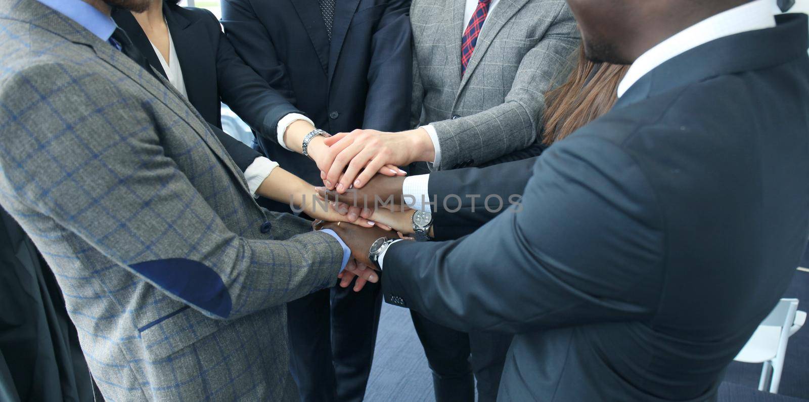Businessman team in suit touching hands together. Selective focus by tsyhun