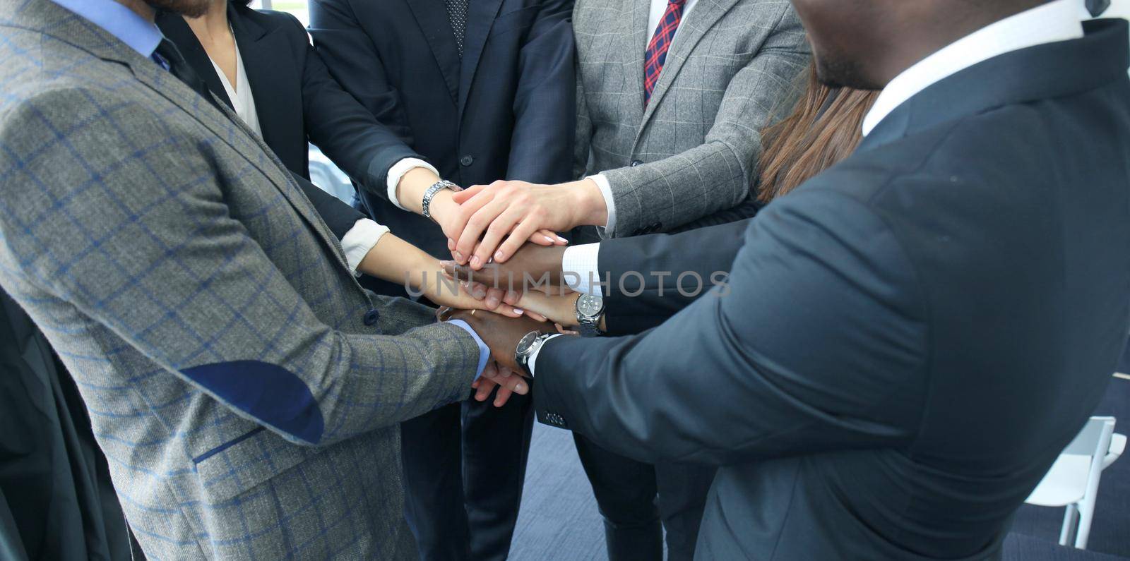 Businessman team in suit touching hands together. Selective focus