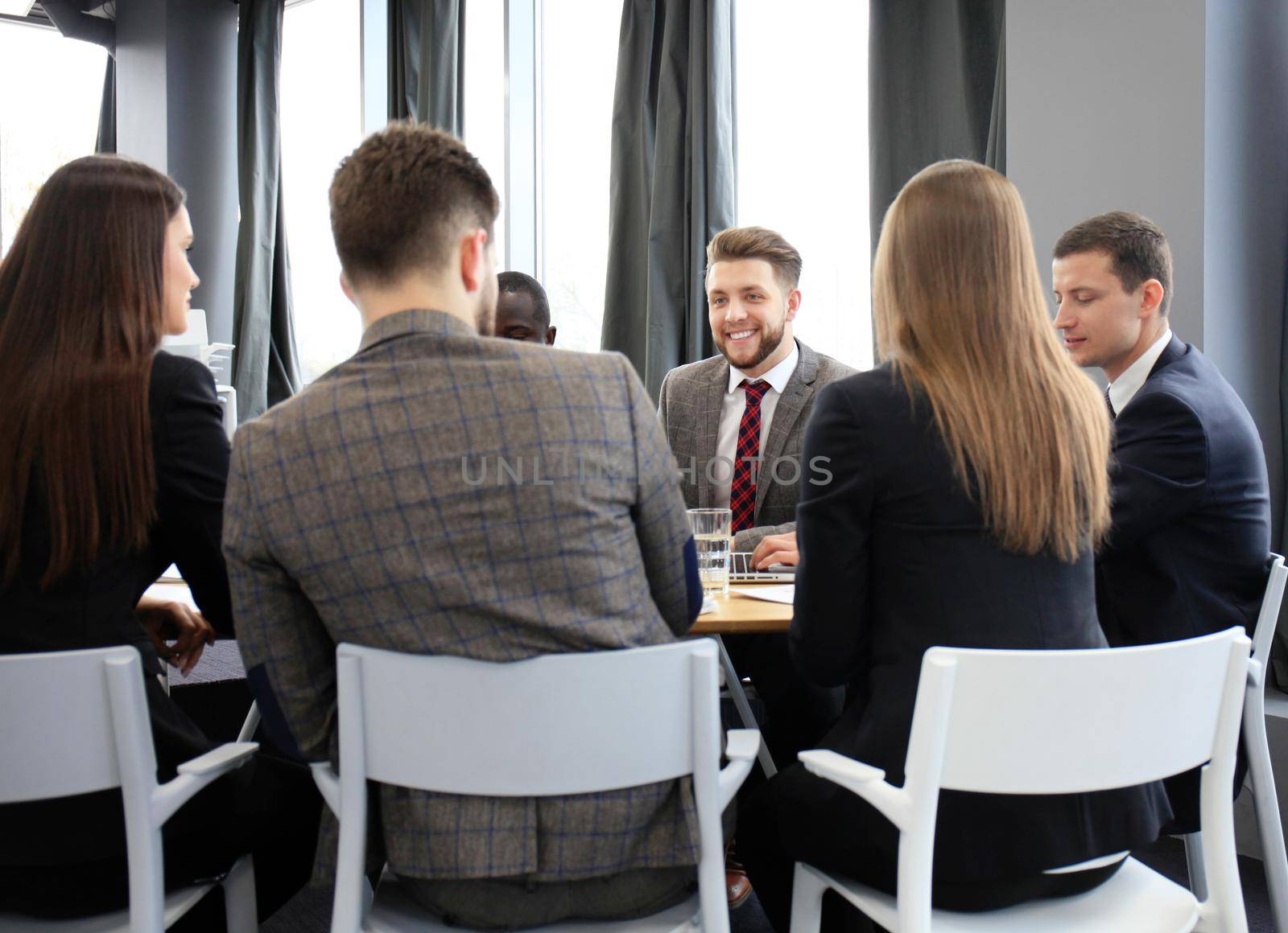 Business team discussing together business plans in office