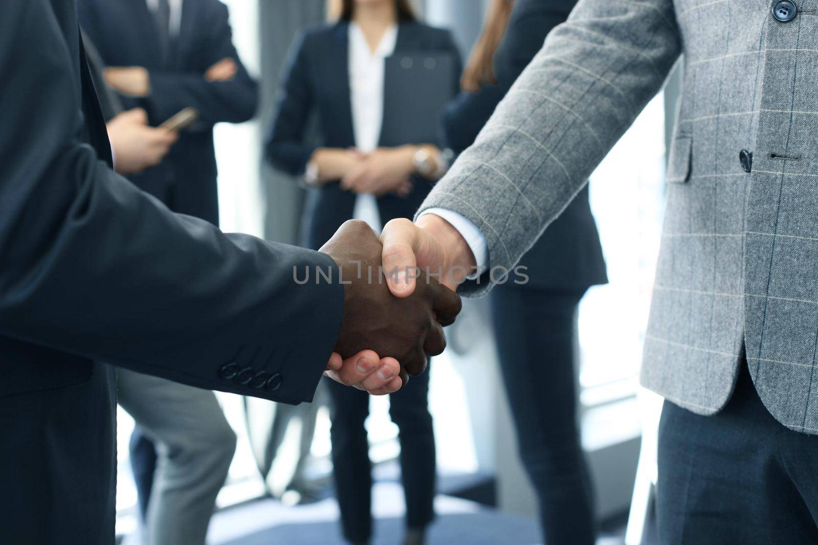 Close up of the businessmen shaking hands.