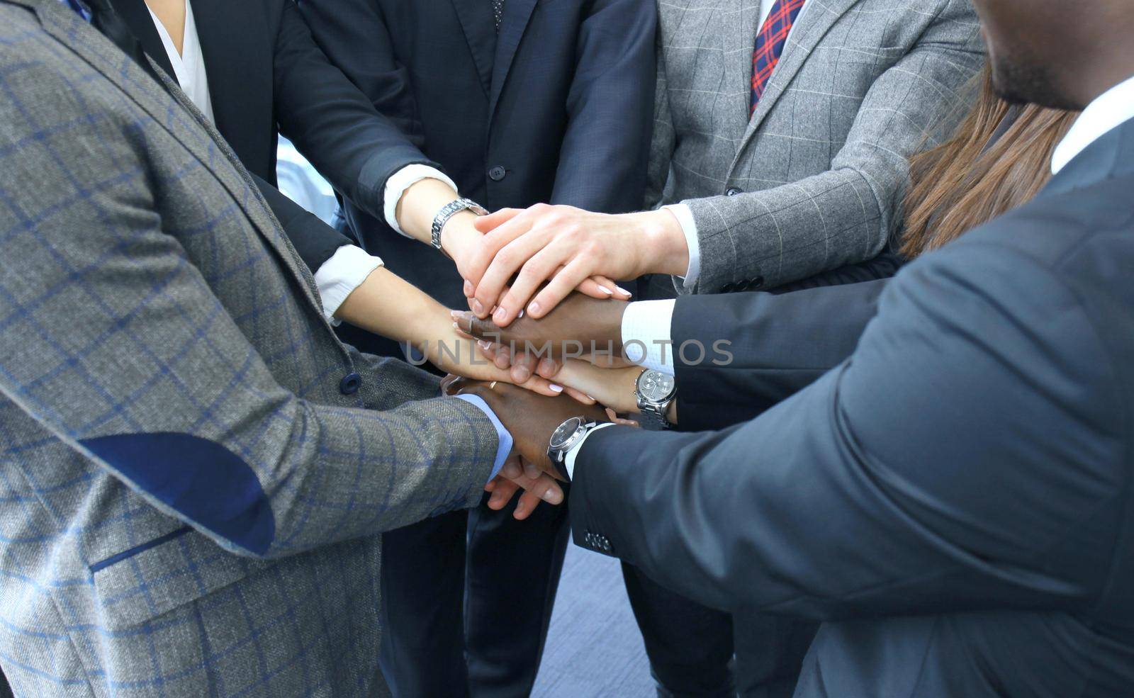 Businessman team in suit touching hands together. Selective focus