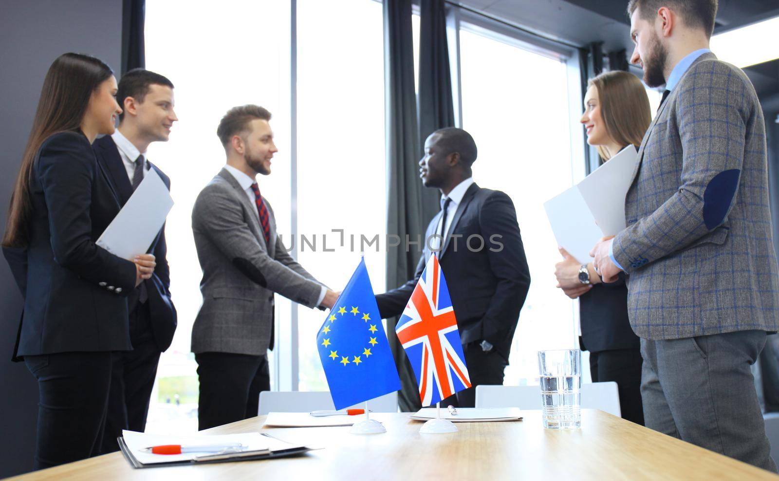 European Union and United Kingdom leaders shaking hands on a deal agreement