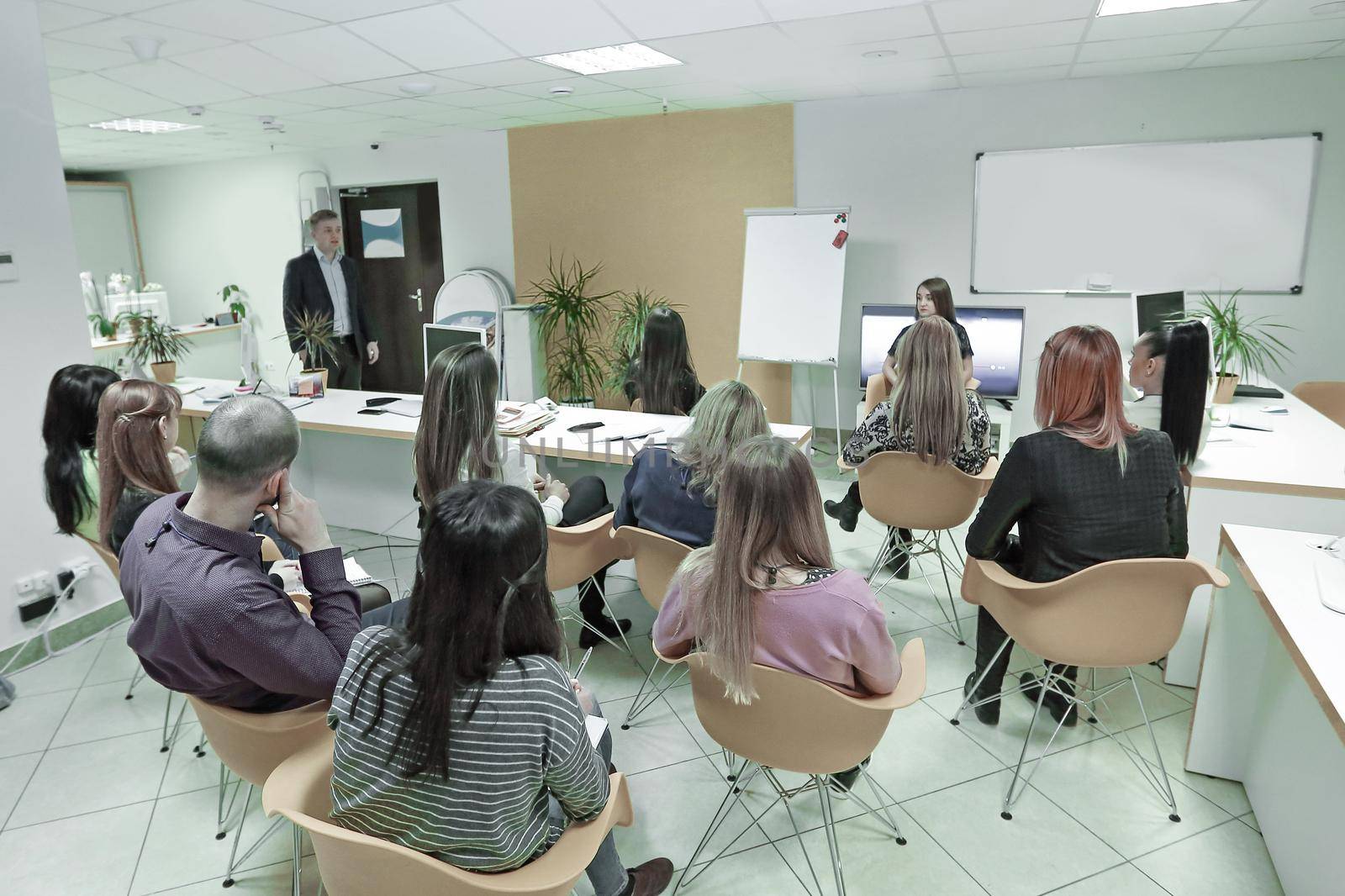 rear view.the speaker making a report at the meeting. by SmartPhotoLab